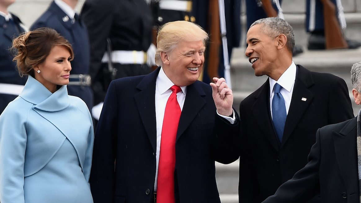 US First Lady Melania Trump looks on as US President Donald Trump and former President Barack Obama talk on the East front steps of the US Capitol after inauguration ceremonies on January 20, 2017 in Washington, DC. / AFP / Robyn BECK (Photo credit should read ROBYN BECK/AFP/Getty Images)