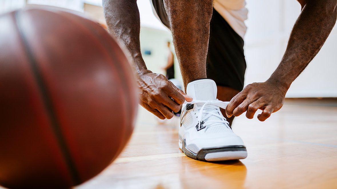 Close up of a basketball player tying up his shoelaces (Getty Images)