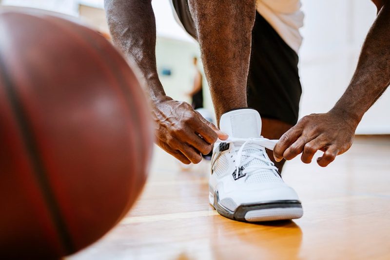 Close up of a basketball player tying up his shoelaces (Getty Images)
