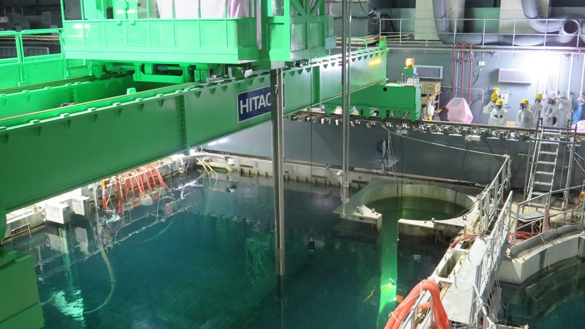 In this handout image provided by Tokyo Electric Power Co, workers remove nuclear fuel rods from a pool at No. 4 reactor of the Fukushima Daiichi Nuclear Power Plant on November 18, 2013 in Okuma, Fukushima, Japan.  TEPCO started removing nuclear fuel from a damaged reactor building for the first time, marking a new stage in the decades-long decommissioning process. The operation to empty the storage pool in the No. 4 reactor building, which holds 1,533 nuclear fuel assemblies, began and expected to be removed by December 2014. But the overall decommissioning work at the stricken nuclear plant is expected to take 30 to 40 years to complete.  (Tokyo Electric Power Co via Getty Images)