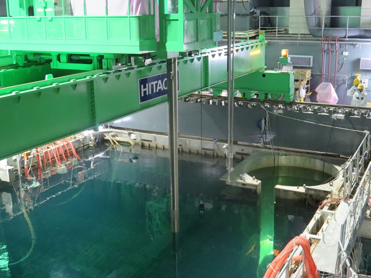In this handout image provided by Tokyo Electric Power Co, workers remove nuclear fuel rods from a pool at No. 4 reactor of the Fukushima Daiichi Nuclear Power Plant on November 18, 2013 in Okuma, Fukushima, Japan. TEPCO started removing nuclear fuel from a damaged reactor building for the first time, marking a new stage in the decades-long decommissioning process. The operation to empty the storage pool in the No. 4 reactor building, which holds 1,533 nuclear fuel assemblies, began and expected to be removed by December 2014. But the overall decommissioning work at the stricken nuclear plant is expected to take 30 to 40 years to complete. (Tokyo Electric Power Co via Getty Images)