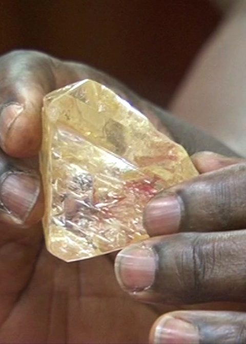 In this photo taken from video footage, Sierra Leone's President Ernest Bai Koroma hands a diamond during a meeting with delegates of Kono district, where the gem was found, at the presidential office in Freetown, Sierra Leone, Thursday, March 16, 2017. A pastor in Sierra Leone has discovered the largest uncut diamond found in more than four decades in this West African country and has turned it over to the government, saying he hopes it helps to boost recent development in his impoverished nation. (SLBC via AP)