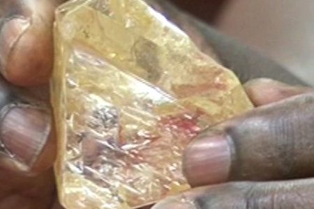 In this photo taken from video footage, Sierra Leone's President Ernest Bai Koroma hands a diamond during a meeting with delegates of Kono district, where the gem was found, at the presidential office in Freetown, Sierra Leone, Thursday, March 16, 2017. A pastor in Sierra Leone has discovered the largest uncut diamond found in more than four decades in this West African country and has turned it over to the government, saying he hopes it helps to boost recent development in his impoverished nation. (SLBC via AP)