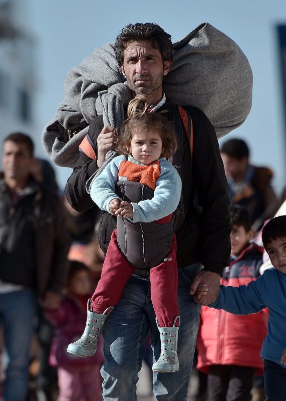 TOPSHOT - Thousands of migrants and refugees walk through the port of Piraeus after arriving from the Greek islands of Lesbos and Chios on February 1, 2016.
On average, more than 1,900 people have arrived each day this month on Greek islands on unseaworthy boats from Turkey, according to the UN, which put the total of new arrivals in January at more than 50,000. More than 31,000 people have been registered on Lesbos during that time, the UN added. / AFP / LOUISA GOULIAMAKI        (Photo credit should read LOUISA GOULIAMAKI/AFP/Getty Images)
