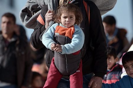 TOPSHOT - Thousands of migrants and refugees walk through the port of Piraeus after arriving from the Greek islands of Lesbos and Chios on February 1, 2016.
On average, more than 1,900 people have arrived each day this month on Greek islands on unseaworthy boats from Turkey, according to the UN, which put the total of new arrivals in January at more than 50,000. More than 31,000 people have been registered on Lesbos during that time, the UN added. / AFP / LOUISA GOULIAMAKI        (Photo credit should read LOUISA GOULIAMAKI/AFP/Getty Images)