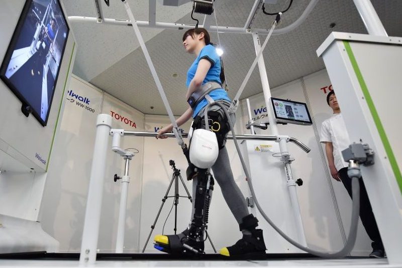 A model demonstrates how the rehabilitation-assist robot Welwalk WW-1000, developed by Japan's Toyota Motor Corporation, helps to assist in flexing and extending the knee while walking on a treadmill during a press preview in Tokyo on April 12, 2017. (Kazuhiro Nogi/AFP/Getty Images)