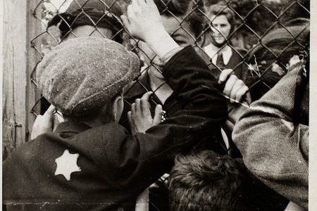 Lodz ghetto: Children talking through fence of central prison on Czarnecki Street prior to deportation (Henryk Ross/Art Gallery of Ontario)