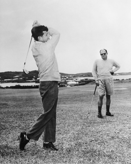 Following his election to the Senate in 1952, John F. Kennedy visited in Bermuda where he displayed a keen interest in golf, playing on the Riddell's Bay Golf & Country Club course with his then host, Mr. Oliver Brooks (right). | Location: Bermuda.