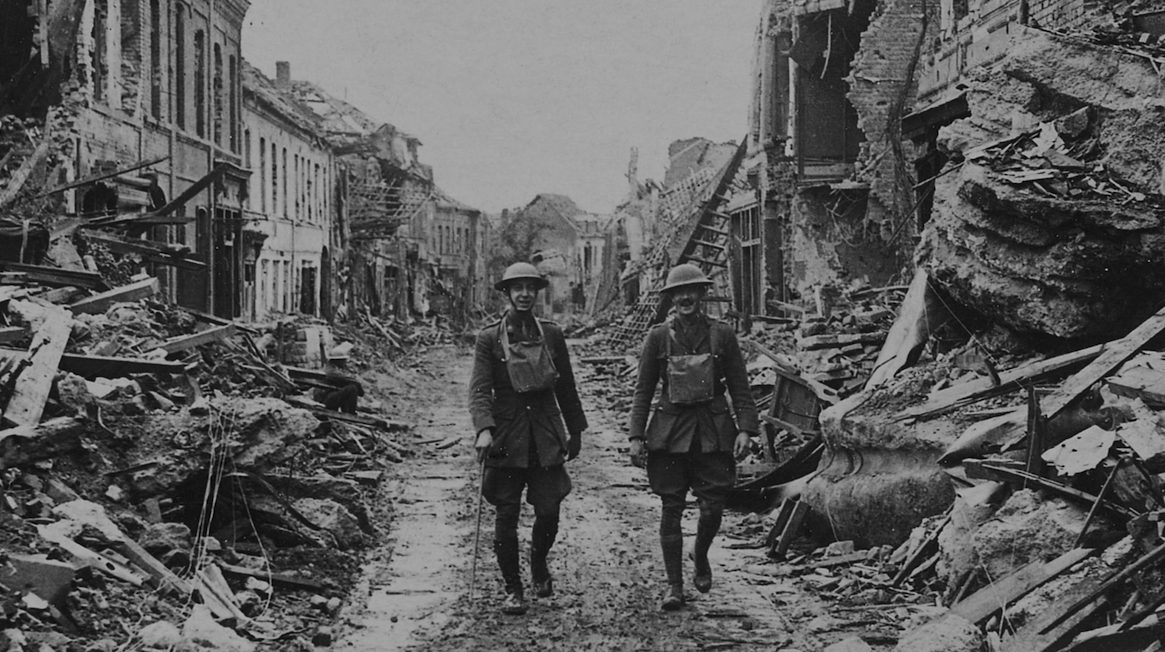 soldiers walking through damaged streets, France. (Photo by Pen & Sword/SSPL/Getty Images)