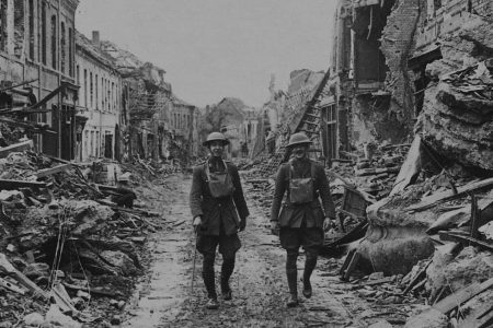 soldiers walking through damaged streets, France. (Photo by Pen & Sword/SSPL/Getty Images)
