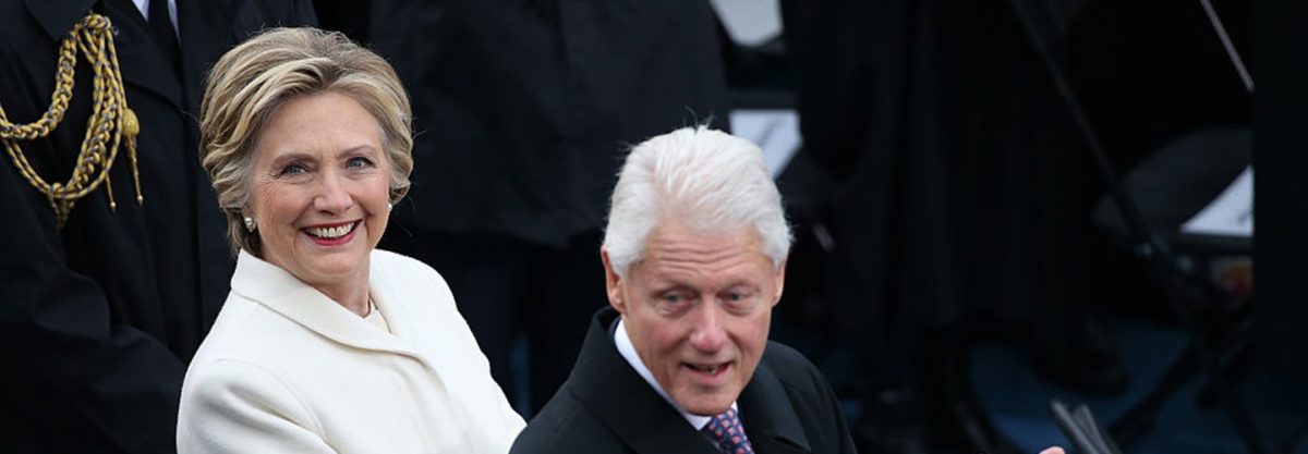 Hillary Clinton, former U.S. Secretary of State, left, and former U.S. President Bill Clinton applaud during the 58th presidential inauguration in Washington, D.C., U.S., on Friday, Jan. 20, 2017.