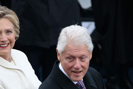 Hillary Clinton, former U.S. Secretary of State, left, and former U.S. President Bill Clinton applaud during the 58th presidential inauguration in Washington, D.C., U.S., on Friday, Jan. 20, 2017.