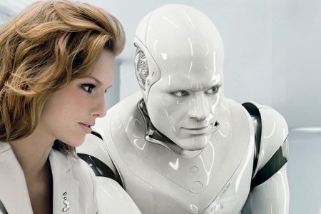 A robot and a businesswoman work side by side.