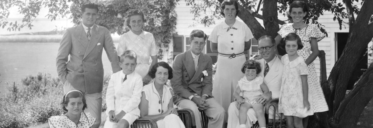 A portrait of the Kennedy family,  1930s. Seated from left are: Patricia Kennedy, Robert Kennedy, Rose Kennedy, John F Kennedy, Joseph P Kennedy Sr with Edward Kennedy on his lap; standing from left are: Joseph P Kennedy Jr, Kathleen Kennedy, Rosemary Kennedy, Eunice Kennedy (rear, in polka dots), and Jean Kennedy. (Bachrach/Getty Images)