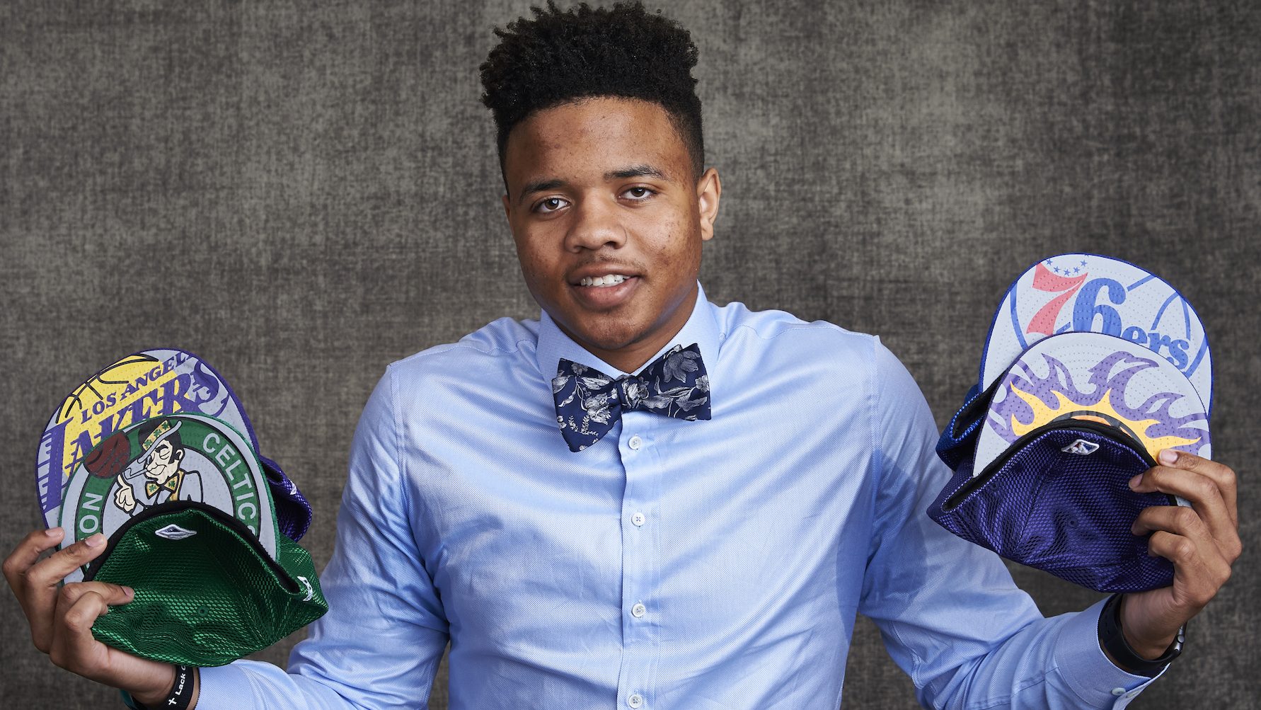 Likely #1 NBA draft pick Markelle Fultz poses with team caps.  (Jennifer Pottheiser/NBAE via Getty Images)