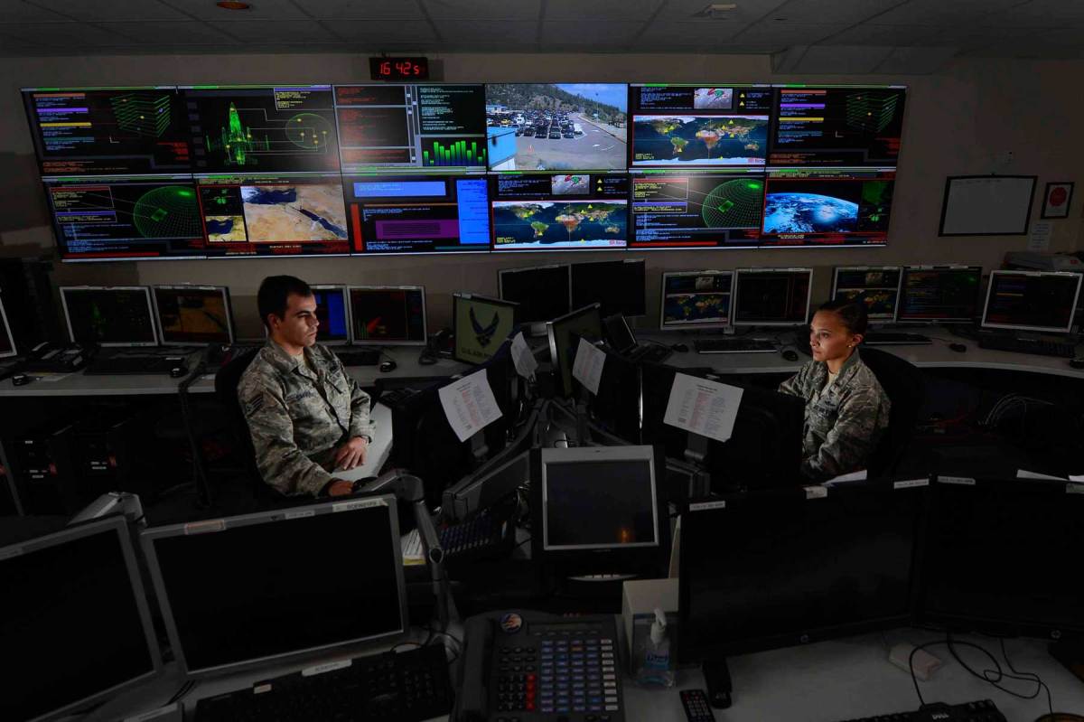 Staff Sgt. Alex Garviria and 2nd Lt. Rachel James work in the Global Strategic Warning and Space Surveillance System Center Sept. 2, 2014, at Cheyenne Mountain Air Force Station, Colo. Garviria is a 721st CS senior systems controller and James is the 721st CS crew commander. (U.S. Air Force photo by Airman 1st Class Krystal Ardrey/Released)

