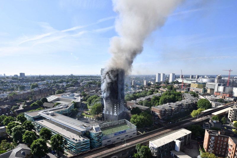 Smoke rises from the building after a huge fire engulfed the 24 story residential Grenfell Tower block in London.
