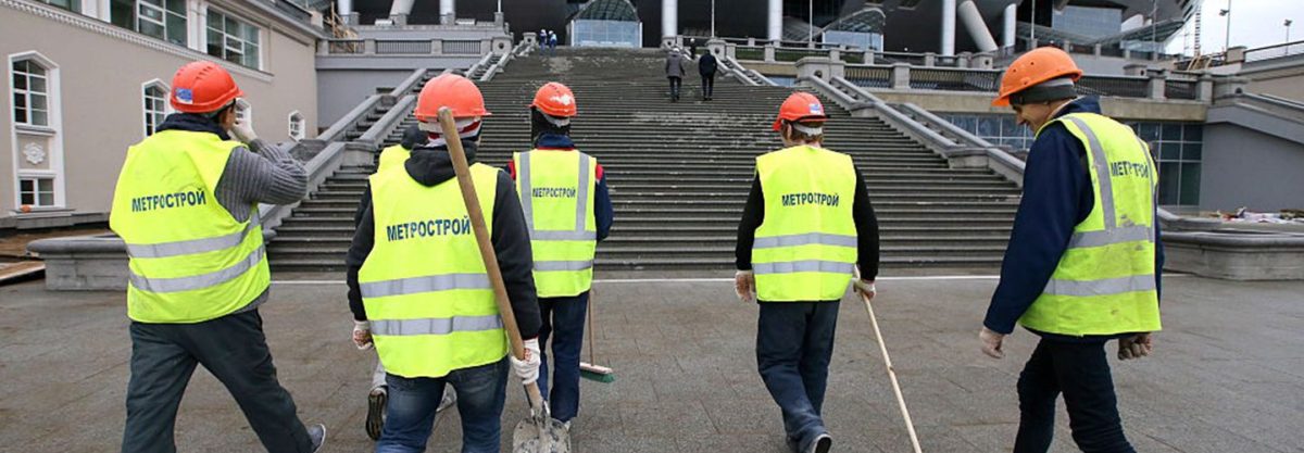 Construction workers walking to Zenit Arena Stadium, one of the venues for the 2018 World Cup in Russia.