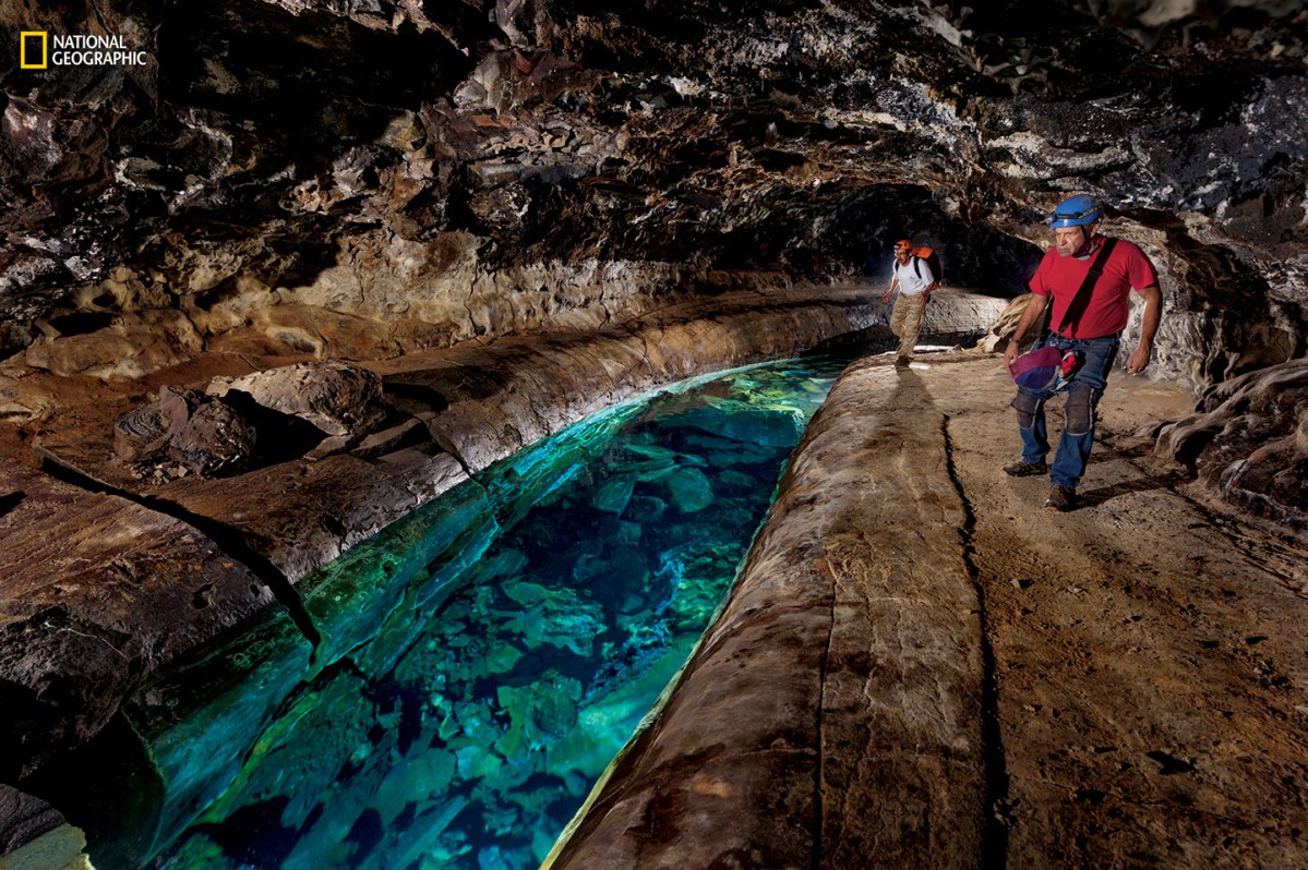 Pristine freshwater pools (right) are rare in Hawaii’s lava tubes. They may look inviting, but explorers say divers can become disoriented in the twisting passages or trapped by blockages or rockfall and run out of air. (Carsten Peter/National Geographic)