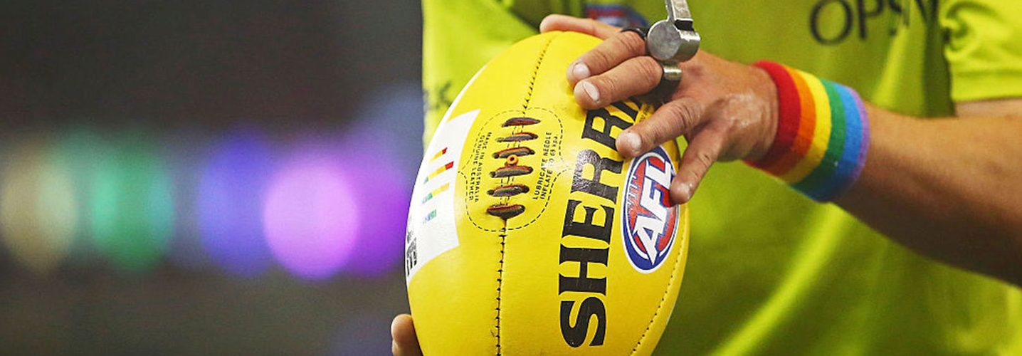 A bounday umpire prepares to throw the ball into play while wearing rainbow-coloured wrist bands during the round 21 AFL match between the St Kilda Saints and the Sydney Swans at Etihad Stadium on August 13, 2016 in Melbourne, Australia. St Kilda and the Sydney Swans played in the inaugural AFL Pride Game, believed to be a world-first in professional sport - celebrating diversity and inclusion of all people in sport. (Photo by Scott Barbour/Getty Images)