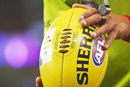 A bounday umpire prepares to throw the ball into play while wearing rainbow-coloured wrist bands during the round 21 AFL match between the St Kilda Saints and the Sydney Swans at Etihad Stadium on August 13, 2016 in Melbourne, Australia. St Kilda and the Sydney Swans played in the inaugural AFL Pride Game, believed to be a world-first in professional sport - celebrating diversity and inclusion of all people in sport. (Photo by Scott Barbour/Getty Images)