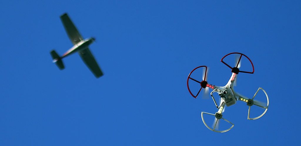 A drone is flown for recreational purposes as an airplane passes nearby in the sky above Old Bethpage, New York on September 5, 2015.  (Photo by Bruce Bennett/Getty Images)