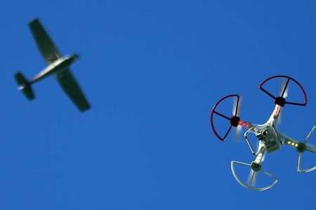 A drone is flown for recreational purposes as an airplane passes nearby in the sky above Old Bethpage, New York on September 5, 2015.  (Photo by Bruce Bennett/Getty Images)