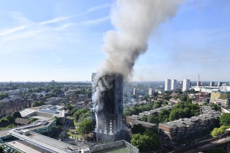 Smoke rises from the building after a huge fire engulfed the 24 story residential Grenfell Tower block in Latimer Road, West London in the early hours of this morning on June 14, 2017 in London, England.
(Photo by Leon Neal/Getty Images)