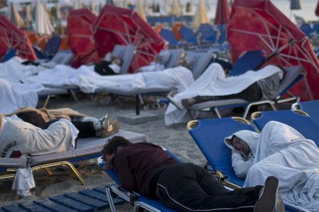 Tourist sleep on sun beds at a beach of the Greek island of Kos, on Saturday, July 22, 2017. Hundreds of residents and tourists on the eastern Greek island of Kos spent the night sleeping outdoors, on beach lounge-chairs, in parks and olive groves or in their cars, a night after a powerful earthquake killed two tourists and injured nearly 500 others across the Aegean Sea region, in Greece and Turkey.