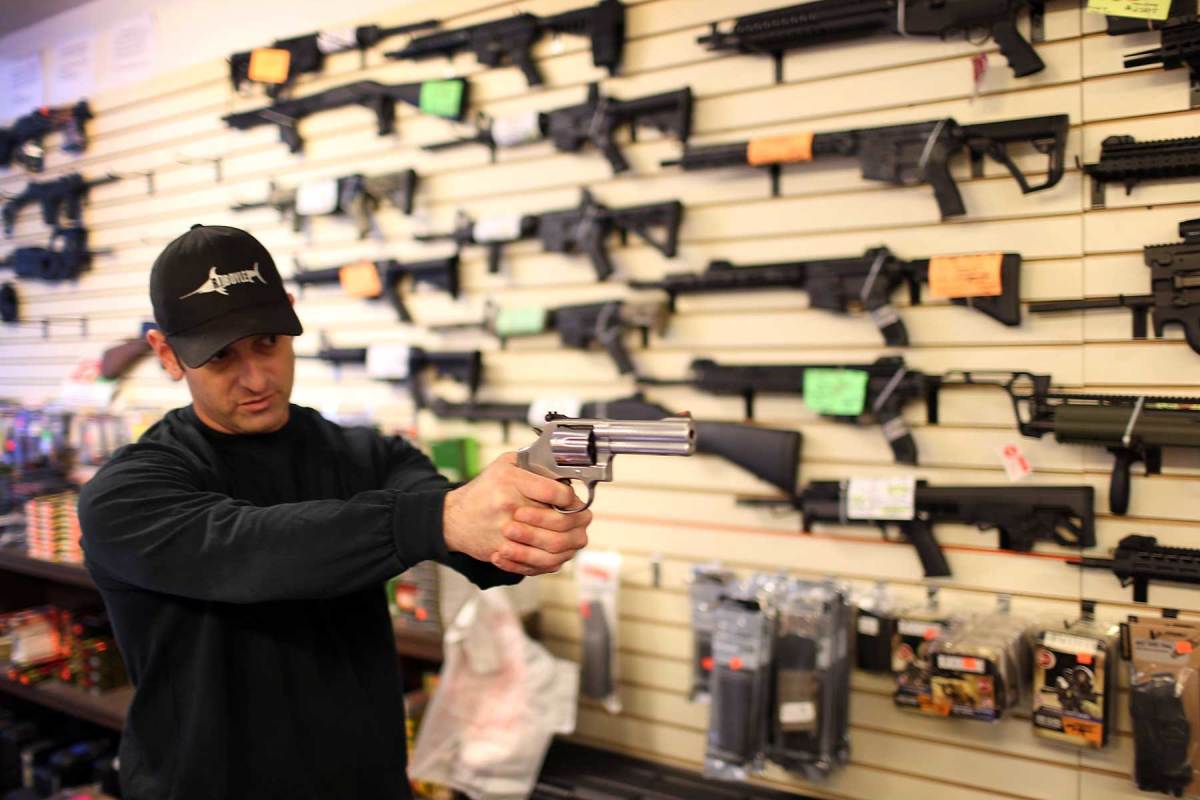Brandon Wexler shows a customer one of the weapons that she was picking up at the end of the three day waiting period at the K&W Gunworks store on the day that U.S. President Barack Obama in Washington, DC announced his executive action on guns on January 5, 2016 in Delray Beach, Florida. (Joe Raedle/Getty Images)