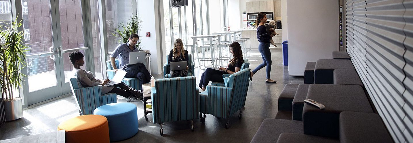 People work on laptop computers at the WPP Plc GroupM agencies' shared office space in the Playa Vista neighborhood of Los Angeles, California, U.S. A new study shows that working long hours increases the risk of an irregular heart rhythm.