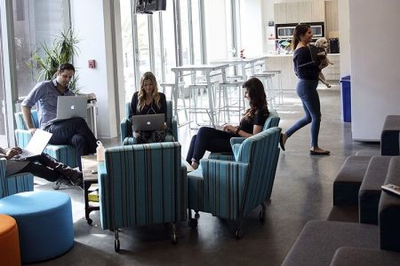 People work on laptop computers at the WPP Plc GroupM agencies' shared office space in the Playa Vista neighborhood of Los Angeles, California, U.S. A new study shows that working long hours increases the risk of an irregular heart rhythm.