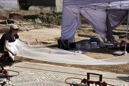 Archaeologists work on a mosaic on July 31, 2017, on the archaeological antiquity site of Sainte-Colombe, near Vienne, eastern France. (Jean-Philippe Ksiazek/AFP/Getty Images)