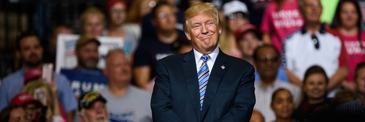 President Donald J. Trump listens as West Virginia Governor Jim Justice announces that he is switching parties to become a republican during the president's campaign rally at the Big Sandy Superstore Arena on August 3, 2017 in Huntington, West Virginia.
