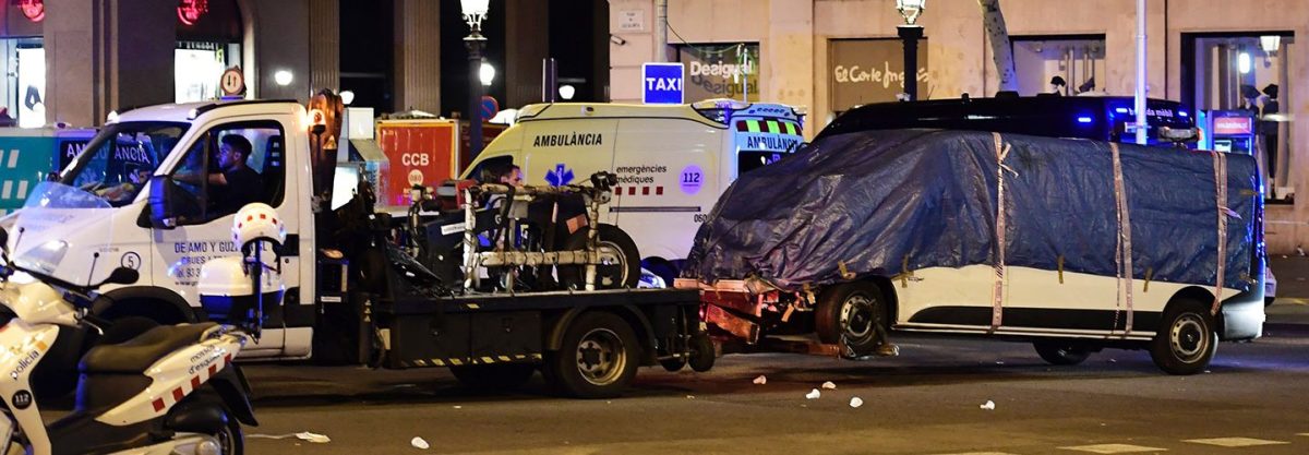 The van who ploughed into the crowd, killing at least 13 people and injuring around 100 others is towed away from the Rambla in Barcelona on August 18, 2017.