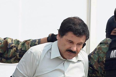 Mexican drug trafficker Joaquin Guzman Loera aka 'el Chapo Guzman' (C), is escorted by marines as he is presented to the press on February 22, 2014 in Mexico City. The Sinaloa cartel leader - the most wanted by US and Mexican anti-drug agencies - was arrested early this morning by Mexican marines at a resort in Mazatlan, northern Mexico. AFP PHOTO/Alfredo Estrella (Getty Images)