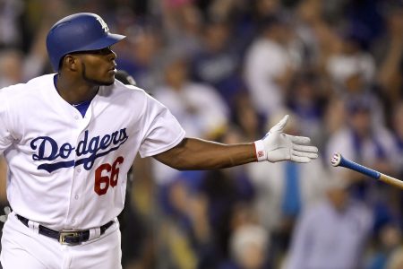 Los Angeles Dodgers' Yasiel Puig watches his home run against the Chicago Cubs during the seventh inning of Game 1 of baseball's National League Championship Series in Los Angeles, Saturday, Oct. 14, 2017. (AP Photo/Mark J. Terrill)