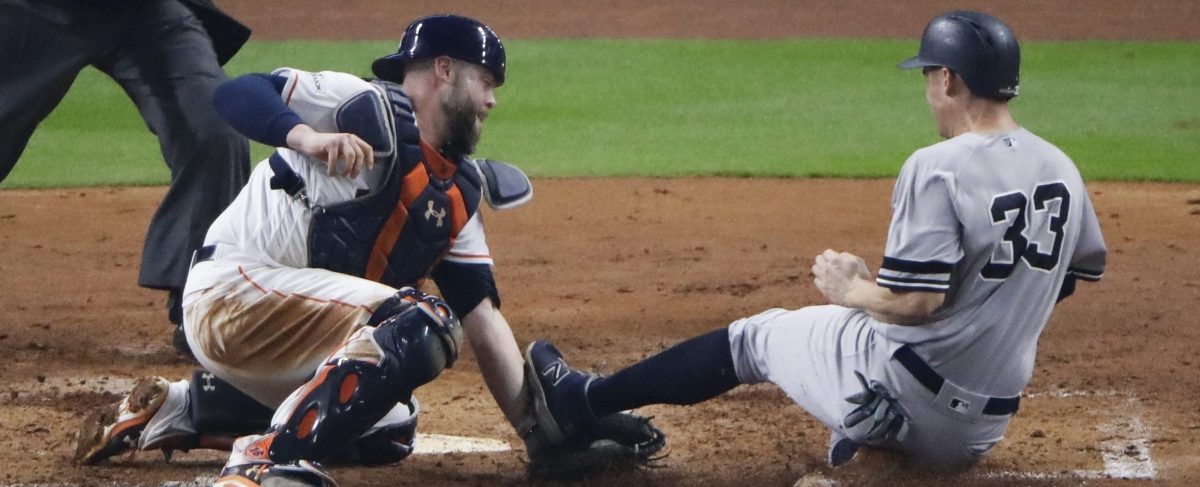 Houston Astros catcher Brian McCann tags out New York Yankees' Greg Bird at home during the fifth inning of Game 7 of baseball's American League Championship Series Saturday, Oct. 21, 2017, in Houston. (AP Photo/Charlie Riedel)