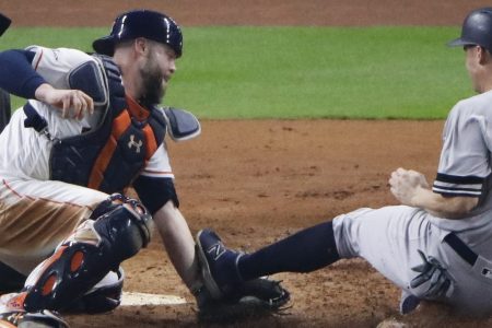 Houston Astros catcher Brian McCann tags out New York Yankees' Greg Bird at home during the fifth inning of Game 7 of baseball's American League Championship Series Saturday, Oct. 21, 2017, in Houston. (AP Photo/Charlie Riedel)