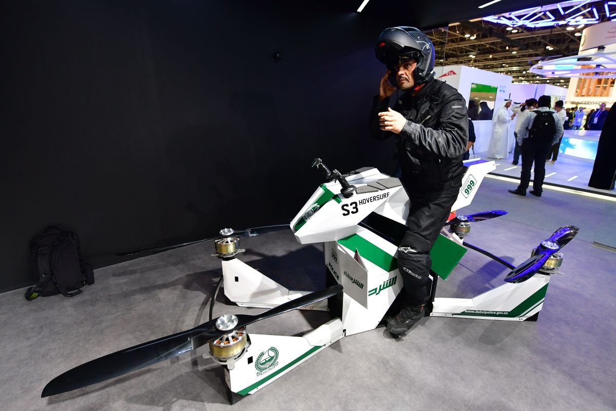 An Emiratee police officer stands next to a drone motorcycle at the Gitex 2017 exhibition at the Dubai World Trade Center in Dubai on October 8, 2017.  / AFP PHOTO / GIUSEPPE CACACE        (Photo credit should read GIUSEPPE CACACE/AFP/Getty Images)