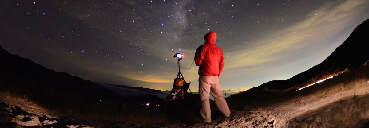 Man standing on Acacia hill and watching star galaxy at night. (Getty)
