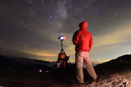 Man standing on Acacia hill and watching star galaxy at night. (Getty)