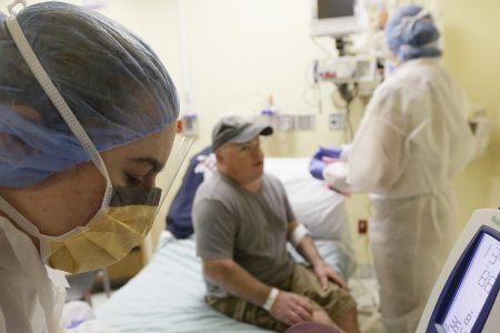 In this photo taken Monday, Nov. 13, 2017, Brian Madeux, 44, has his vitals checked before receiving the first human gene editing therapy for Hunter syndrome, at the UCSF Benioff Children's Hospital in Oakland, Calif. (AP Photo/Eric Risberg)