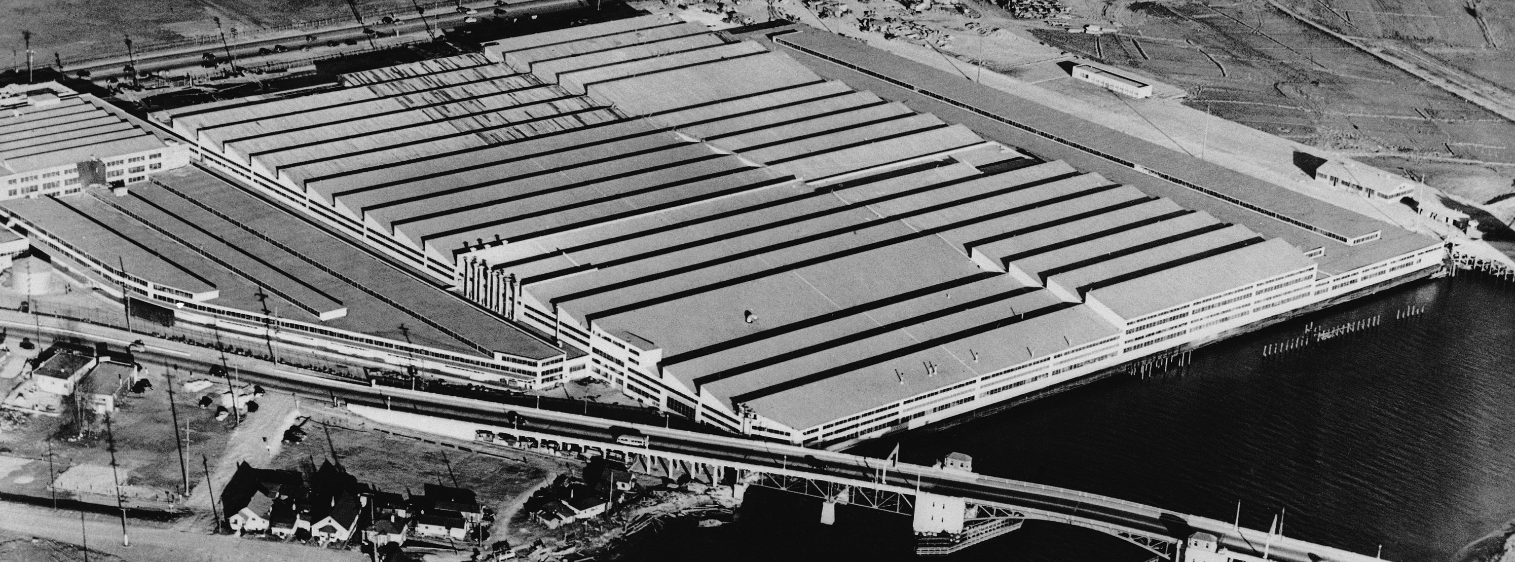 Aerial view of Boeing Aircraft Co., plant at Seattle, Washington June 18, 1941, nine-tenths of this 42-acre development was added during the year ending May 1941. At extreme left may be seen part of the four-story building housing engineering and production departments. (AP Photo)