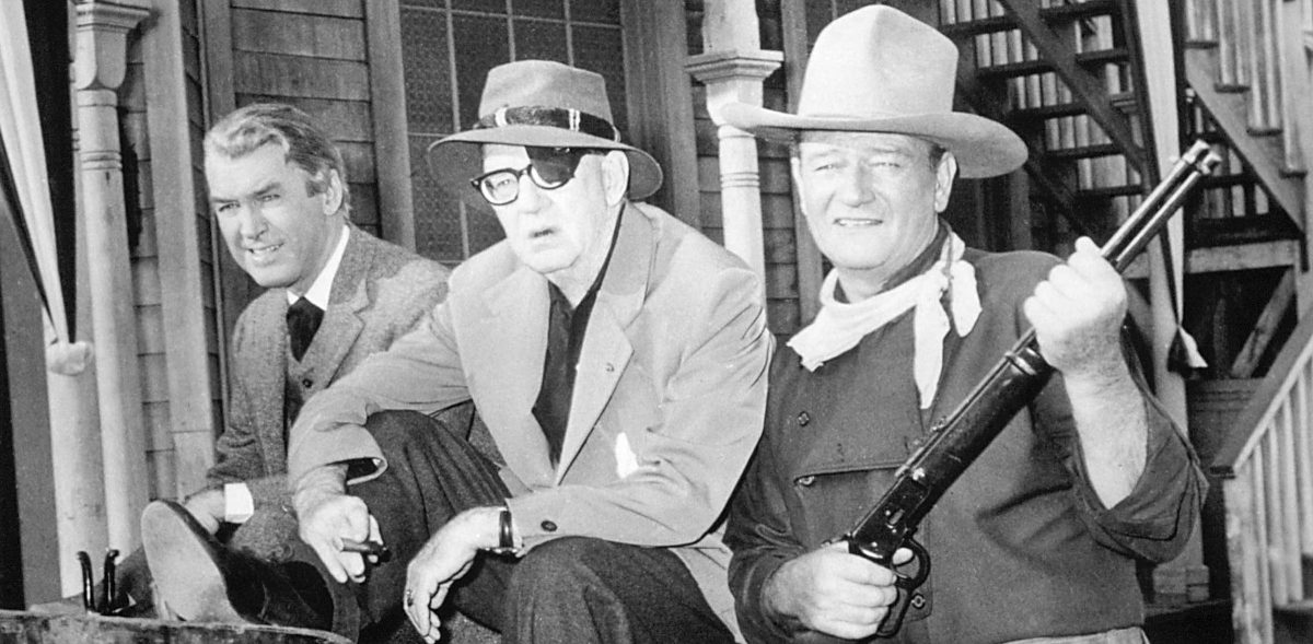 American actors James Stewart (1908 - 1997, left ) and John Wayne (1907 - 1979, right) with director John Ford (1894 - 1973) on the set of? 'The Man Who Shot Liberty Valance', 1962. (Photo by Silver Screen Collection/Getty Images)
