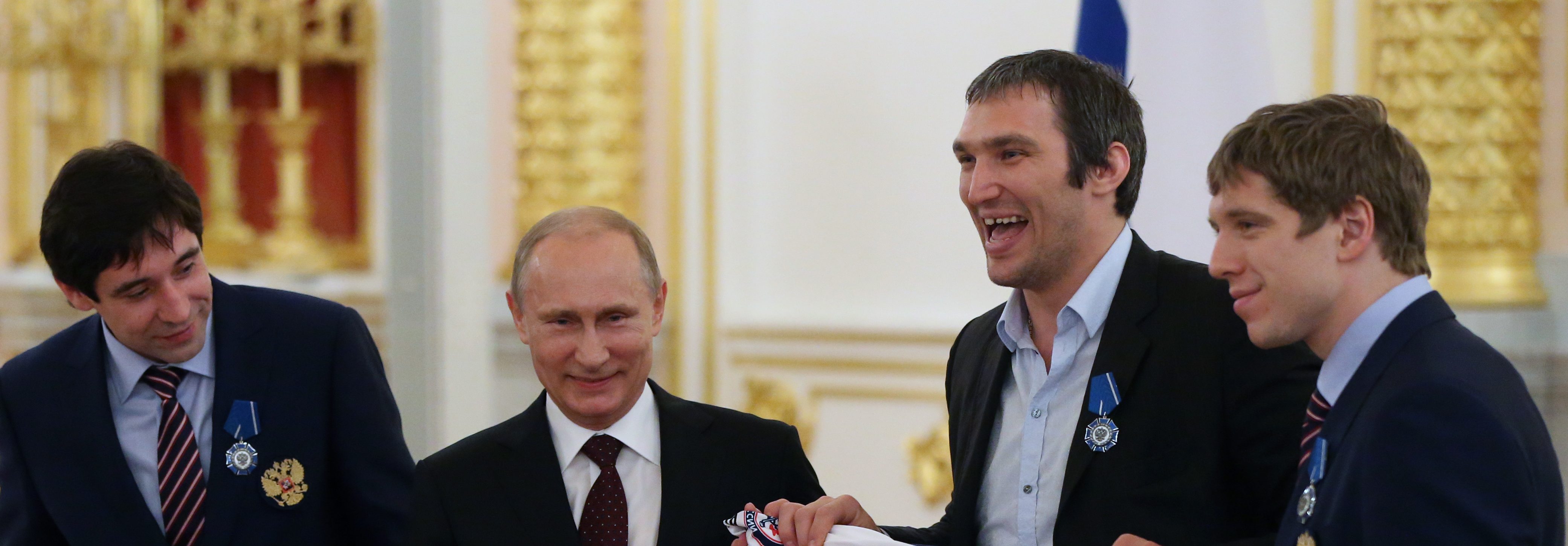 Russian President Vladimir Putin (left) poses for a photo with Russian ice hockey team players Alexander Ovechkin (center) and Nikolay Kulyomin at the Kremlin May 27, 2014 in Moscow, Russia. (Photo by Sasha Mordovets/Getty Images)