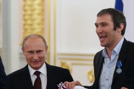 Russian President Vladimir Putin (left) poses for a photo with Russian ice hockey team players Alexander Ovechkin (center) and Nikolay Kulyomin at the Kremlin May 27, 2014 in Moscow, Russia. (Photo by Sasha Mordovets/Getty Images)