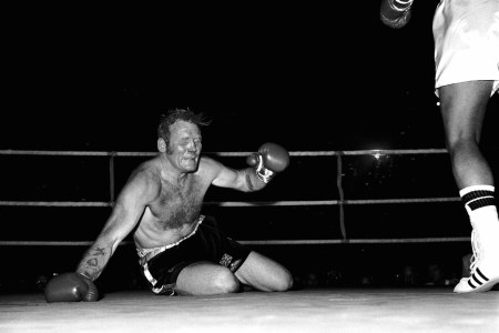 Richard Dunn grimaces as he hits the canvas again, one of five knockdowns he suffered during his 1976 fight against Muhammad Ali, one of boxing's great mismatches.  (PA Images via Getty Images)