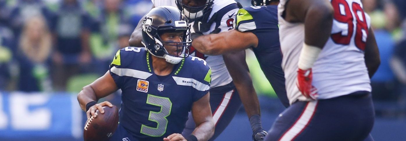 Quarterback Russell Wilson #3 of the Seattle Seahawks escapes to go on a 21 yard run against the Houston Texans during the fourth quarter of the game at CenturyLink Field on October 29, 2017 in Seattle, Washington. (Photo by Jonathan Ferrey/Getty Images)