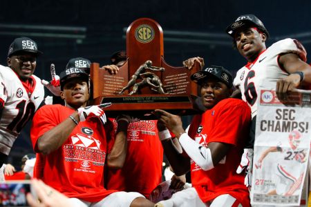 The Georgia Bulldogs hold up the SEC Championship trophy after the SEC Championship game of the Georgia Bulldogs v Auburn Tigers at Mercedes-Benz Stadium in Atlanta, GA. (Todd Kirkland/Icon Sportswire via Getty Images)